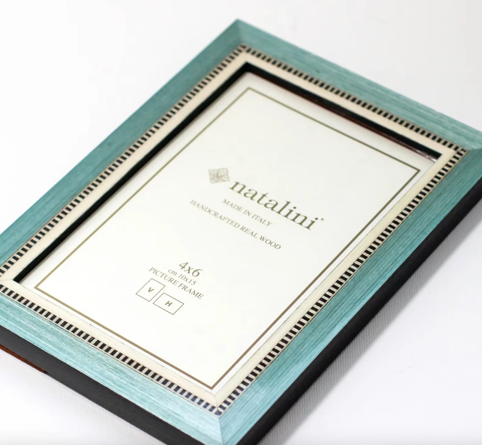 Teal picture frame with 'natalini' branding on a white background