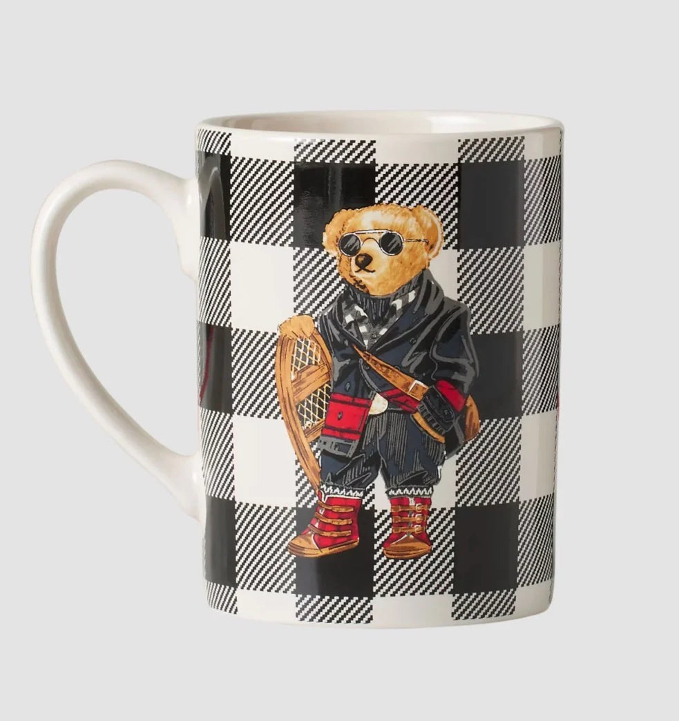 Mug with a checkered pattern and bear design on a plain background