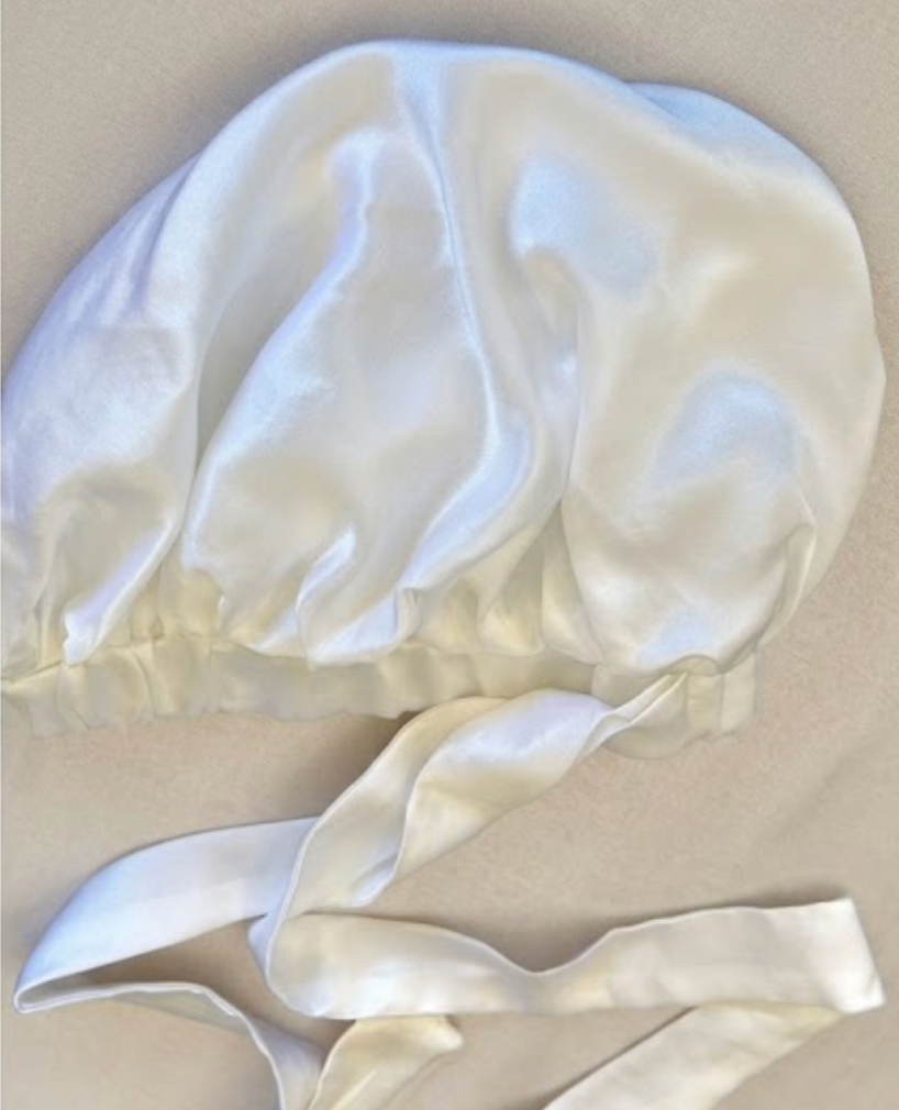 White silk bonnet on a beige background