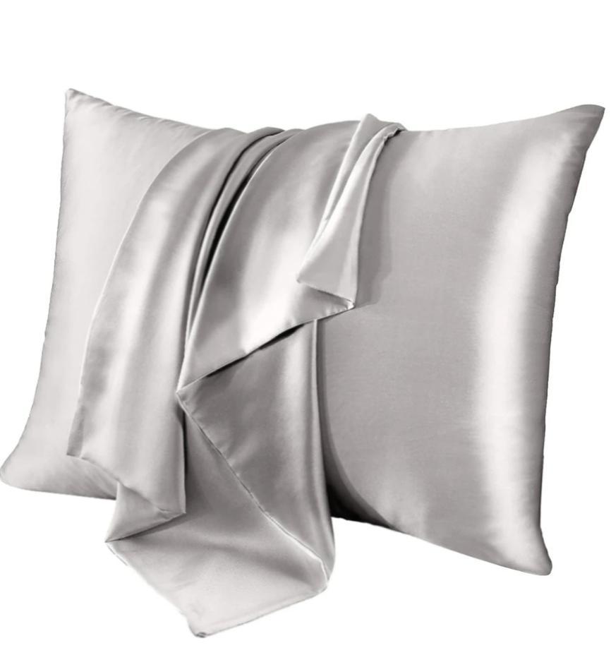 Two silver real mulberry ipek yastık on a white background