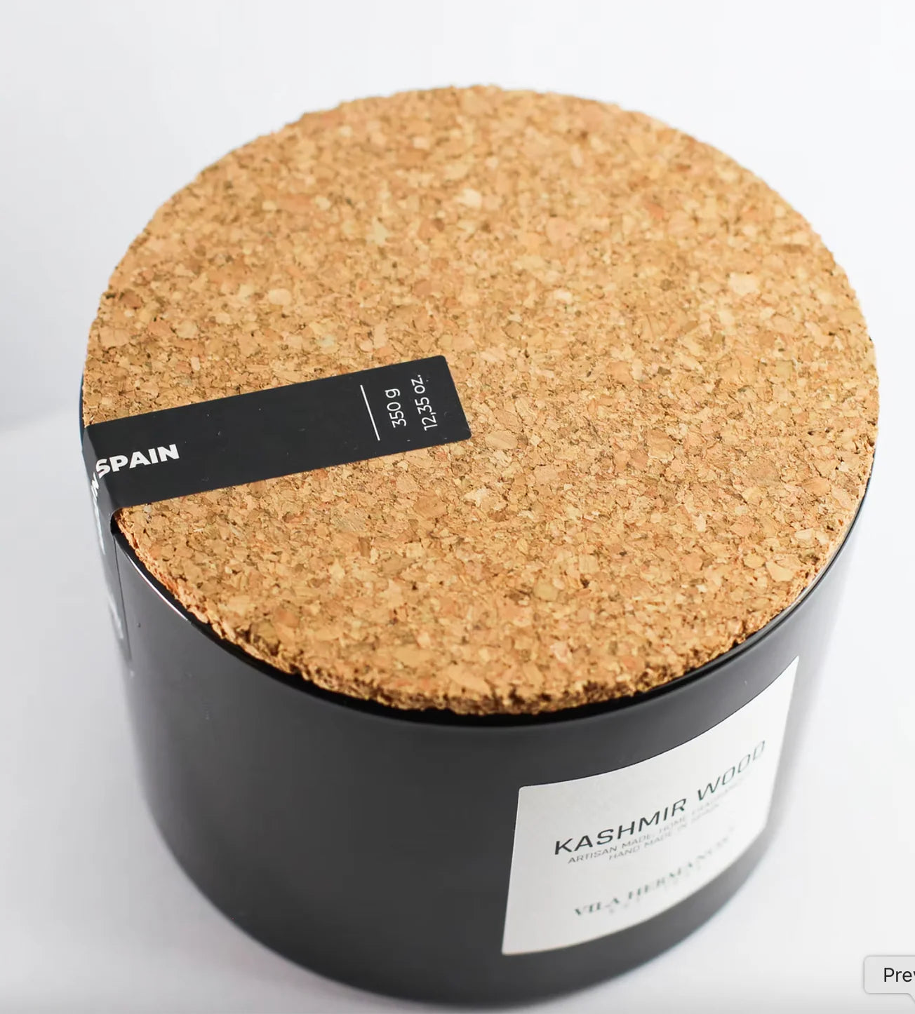Round cork product with a black label on a white background