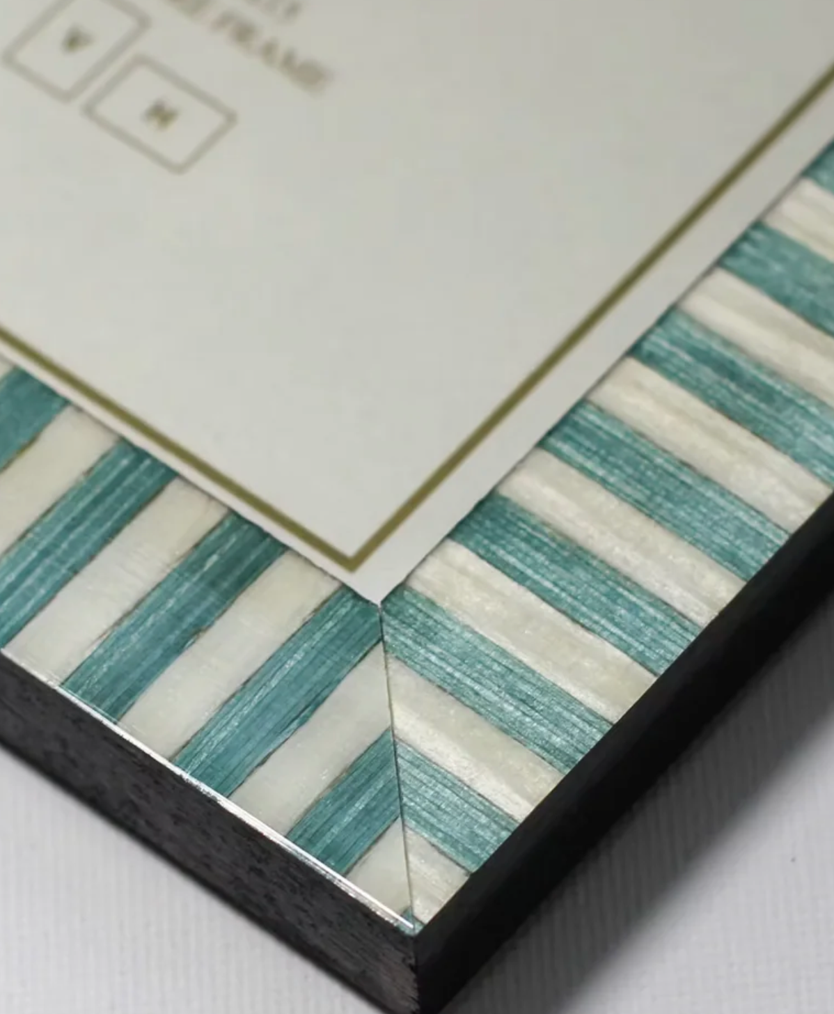 Close-up of a decorative tile with striped pattern on a white background